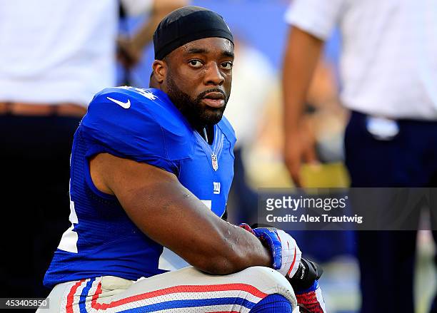 Running back Andre Williams of the New York Giants stretches prior to a preseason game against the Pittsburgh Steelers at MetLife Stadium on August...