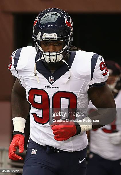 Linebacker Jadeveon Clowney of the Houston Texans runs out onto the field before the preseason NFL game against the Arizona Cardinals at the...