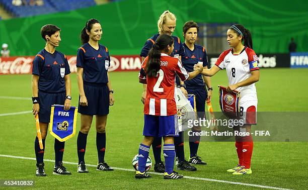 Jennifer Mora of Paraguay and Mariana Benavides of Costa Rica shake hands the FIFA U-20 Women's World Cup 2014 group D match between Paraguay and...