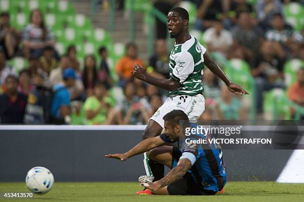 Jorge Djaniny Tavares of Santos vies for the ball with Miguel Angel Martinez of Queretaro, during their Mexican Apertura tournament football match at...