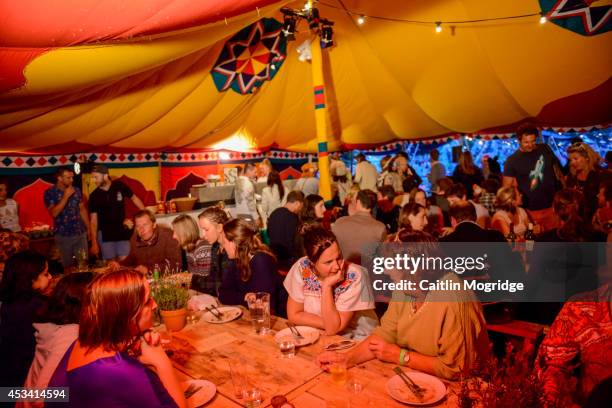 Festival goers eat at the Moro Souk banquet at Wilderness Festival at Cornbury Park on August 9, 2014 in Oxford, United Kingdom.