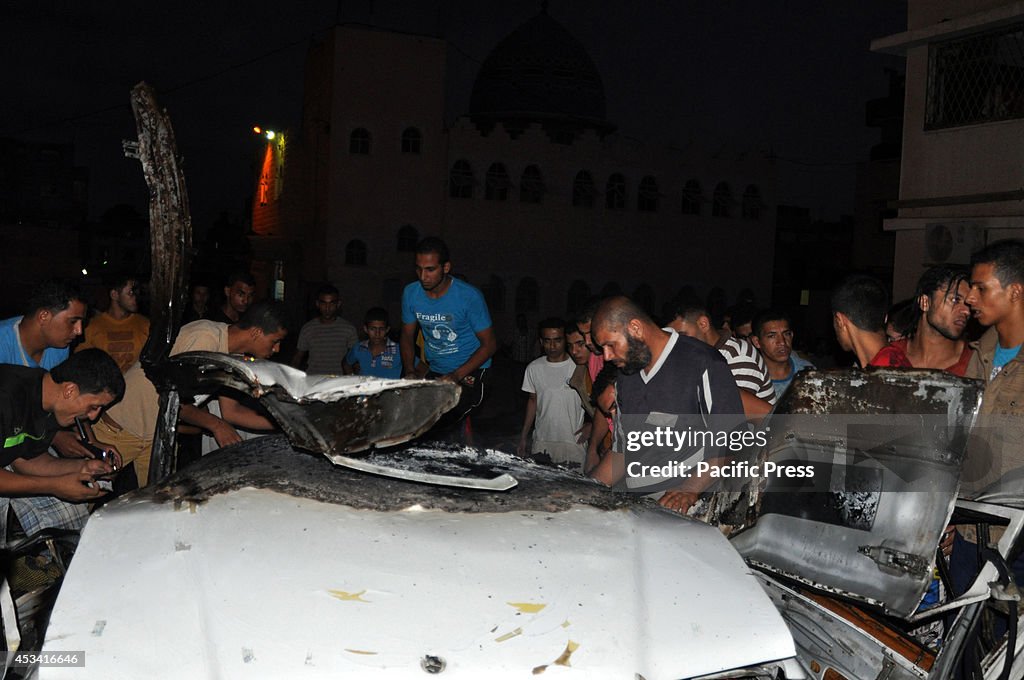 Local residents checking the wreckage of a car, which was...