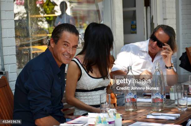 Alfred Culbreth, Adriana de Moura, and Frederic Marq are seen at Pierre's on August 9, 2014 in Bridgehampton, New York.