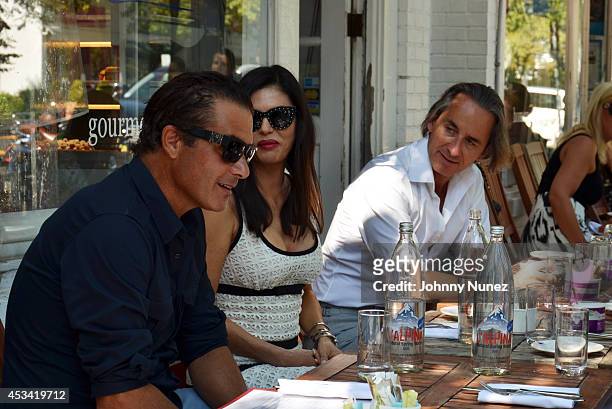 Alfred Culbreth, Adriana de Moura, and Frederic Marq are seen at Pierre's on August 9, 2014 in Bridgehampton, New York.