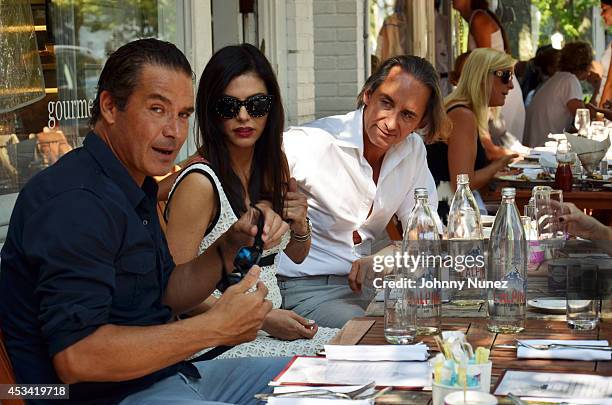 Alfred Culbreth, Adriana de Moura, and Frederic Marq are seen at Pierre's on August 9, 2014 in Bridgehampton, New York.