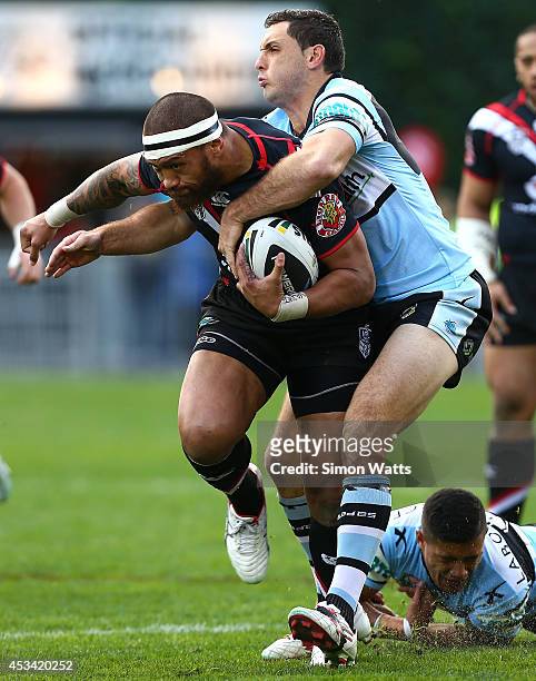 Manu Vatuvei of the Warriors is tackled by Jonathon Wright of the Sharks during the round 22 NRL match between the New Zealand Warriors and the...