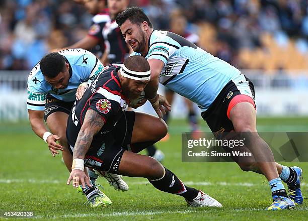 Manu Vatuvei of the Warriors is tackled by Andrew Fifita of the Sharks during the round 22 NRL match between the New Zealand Warriors and the...