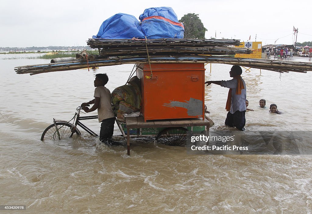 Local residents transporting materials on a rickshaw through...