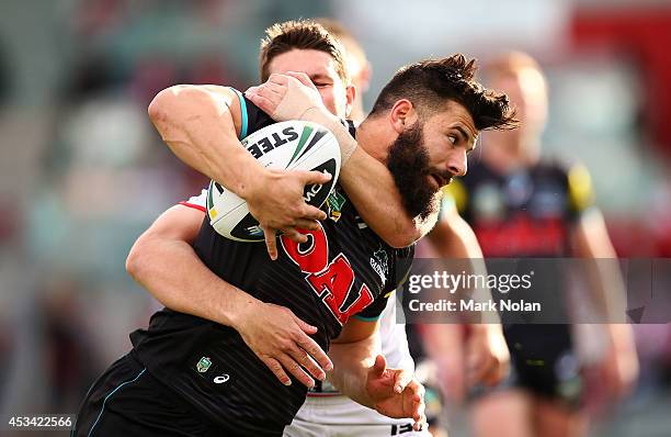 Josh Mansour of the Panthers is atckled during the round 22 NRL match between the St George Dragons and the Penrith Panthers at WIN Stadium on August...