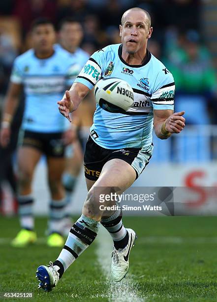 Jeff Robinson of the Sharks passes during the round 22 NRL match between the New Zealand Warriors and the Cronulla Sharks at Mt Smart Stadium on...