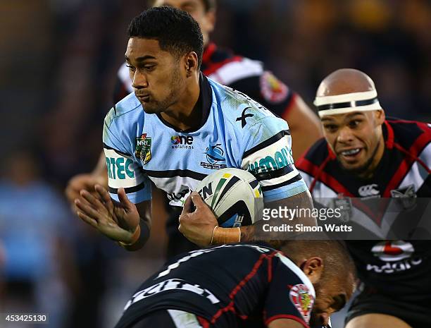 Ricky Leutele of the Sharks looks to beat the Warriors defense during the round 22 NRL match between the New Zealand Warriors and the Cronulla Sharks...