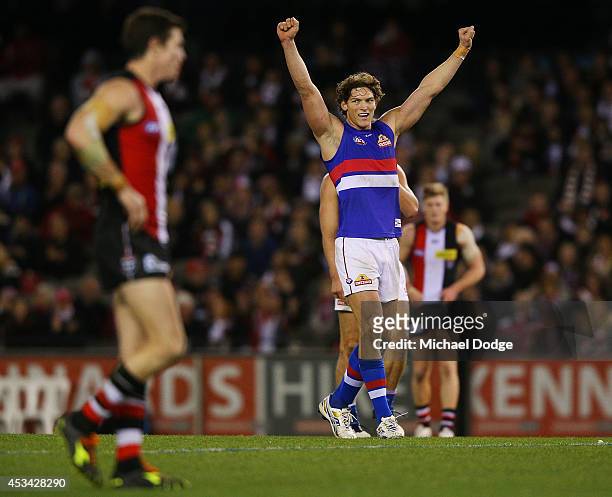 Will Minson of the Bulldogs celebrates victory on the siren next to Lenny Hayes of the Saints who played his last home game ever during the round 20...