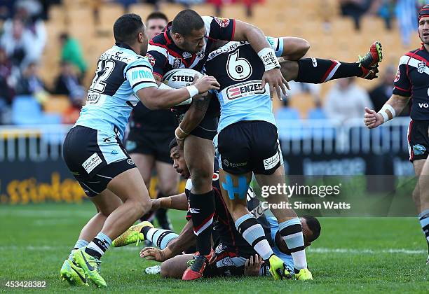Suaia Matagi of the Warriors is lifted in a tackle during the round 22 NRL match between the New Zealand Warriors and the Cronulla Sharks at Mt Smart...