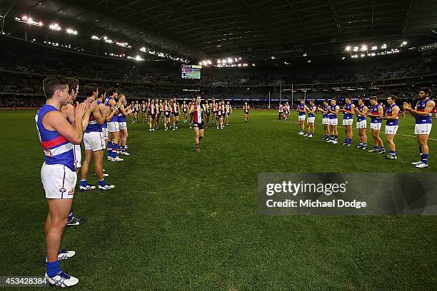 Lenny Hayes of the Saints walks off after his last home game as a guard of honour is provided by teamates and Bulldogs players during the round 20...