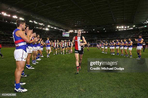 Lenny Hayes of the Saints walks off after his last home game as a guard of honour is provided by teamates and Bulldogs players during the round 20...