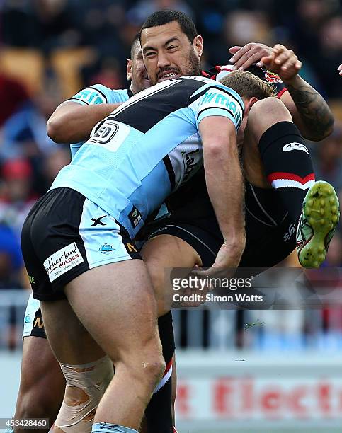 Feleti Mateo of the Warriors is lifted in a tackle during the round 22 NRL match between the New Zealand Warriors and the Cronulla Sharks at Mt Smart...