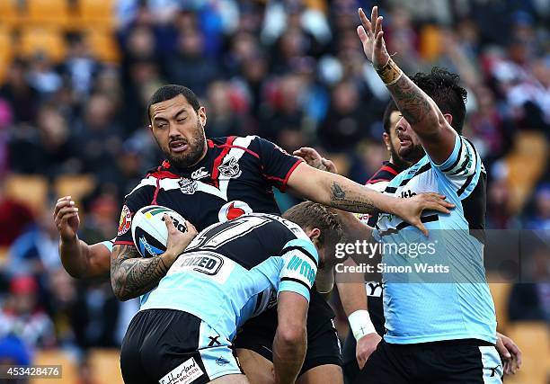 Feleti Mateo of the Warriors is lifted in a tackle during the round 22 NRL match between the New Zealand Warriors and the Cronulla Sharks at Mt Smart...