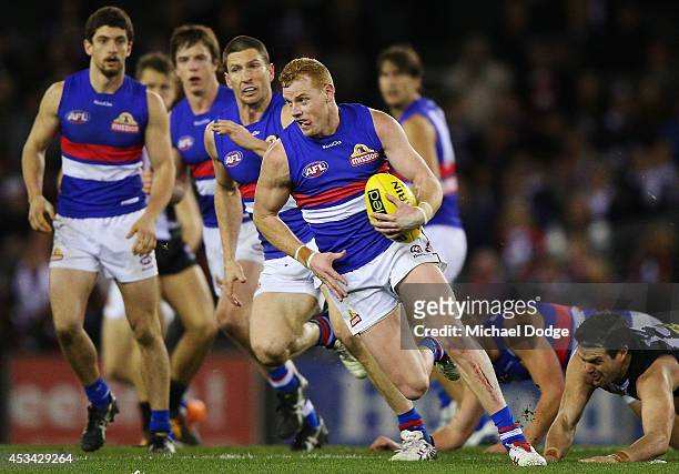 Adam Cooney of the Bulldogs runs with the ball during the round 20 AFL match between the St Kilda Saints and the Western Bulldogs at Etihad Stadium...