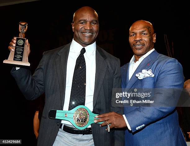 Former boxer Evander Holyfield is inducted into the Nevada Boxing Hall of Fame by former boxer Mike Tyson at the second annual induction gala at the...