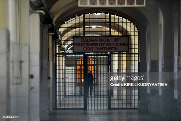 Guard stands in a passage of the notorious Butyrka remand prison in Moscow, on December 4, 2013. The poster reeads: "The family life is the only game...