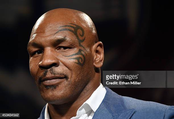 Former boxer Mike Tyson inducts Evander Holyfield into the Nevada Boxing Hall of Fame at the second annual induction gala at the New Tropicana Las...
