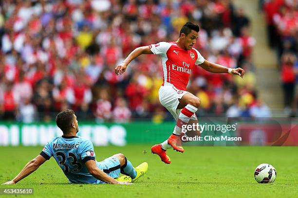 Alexis Sanchez of Arsenal competes for the ball with Matija Nastasic of Manchester City during the FA Community Shield match Manchester City and...