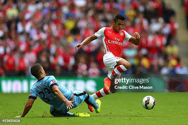 Alexis Sanchez of Arsenal competes for the ball with Matija Nastasic of Manchester City during the FA Community Shield match Manchester City and...