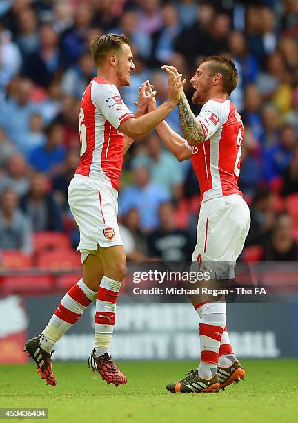 Aaron Ramsey of Arsenal is congratulated on scoring their second goal by Mathieu Debuchy of Arsenal during the FA Community Shield match between...