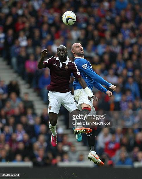 Morgaro Gomis of Hearts vies with Kris Boyd of Rangers during the Scottish Championship Opening League Match between Rangers and Hearts, at Ibrox...