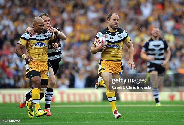 Liam Finn of Castleford Tigers races clear before going over for a try during the Tetley's Challenge Cup Semi Final match between Widnes Vikings and...