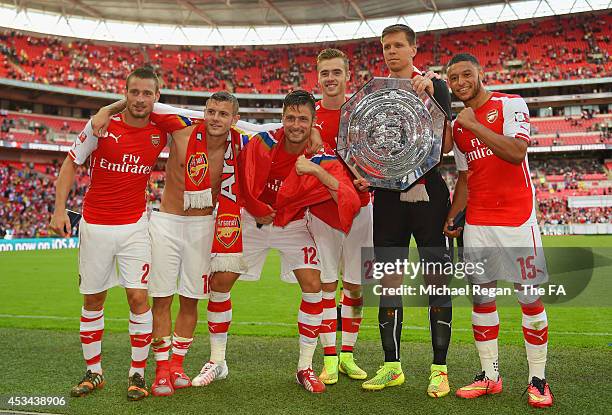 Mathieu Debuchy, Jack Wilshere, Olivier Giroud, Calum Chambers, Wojciech Szczesny and Alex Oxlade-Chamberlain of Arsenal pose with the FA Community...