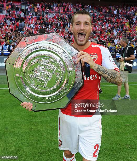 Arsenal's Mathieu Debuchy celebrates after the FA Community Shield match between Arsenal and Manchester City at Wembley Stadium on August 10, 2014 in...