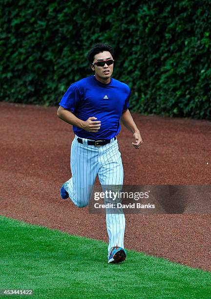 Tsuyoshi Wada of the Chicago Cubs runs in the outfield before the game against the Tampa Bay Rays on August 10, 2014 at Wrigley Field in Chicago,...