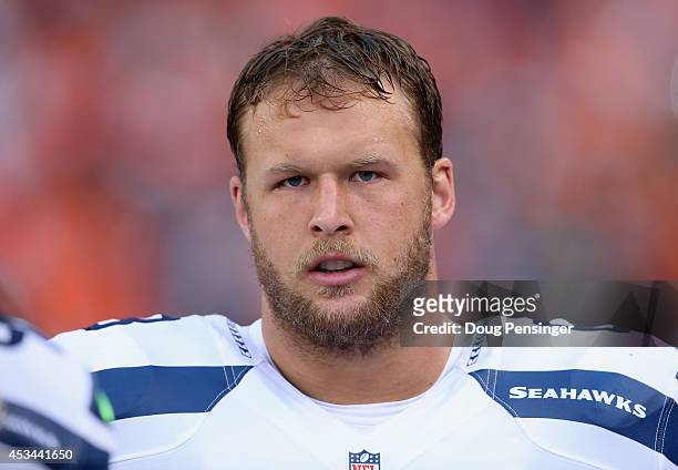 Guard Stephen Schilling of the Seattle Seahawks looks on from the bench against the Denver Broncos at Sports Authority Field at Mile High on August...