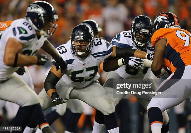 Guard Stephen Schilling of the Seattle Seahawks and center Lemuel Jeanpierre of the Seattle Seahawks block against the Denver Broncos during...