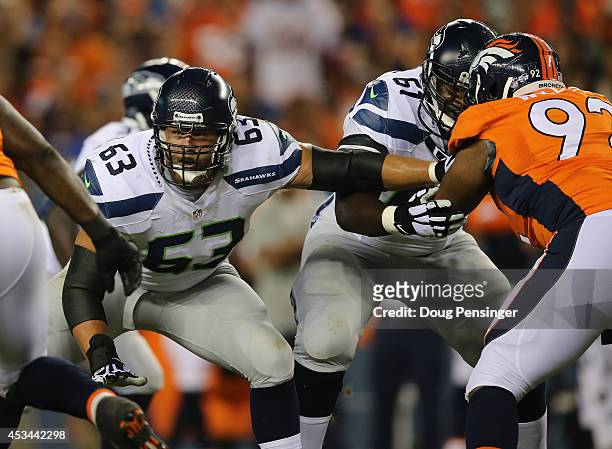 Guard Stephen Schilling of the Seattle Seahawks and center Lemuel Jeanpierre of the Seattle Seahawks block against the Denver Broncos during...