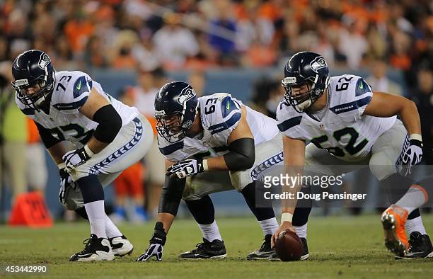 Offensive tackle Eric Winston, guard Stephen Schilling and center Greg Van Roten of the Seattle Seahawks line up against the Denver Broncos during...