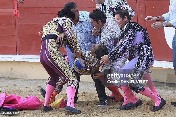 Spanish matador Yvan Fandino is carried out of the arena after being injured by a bull during his bullfight held as part of the August feria in...