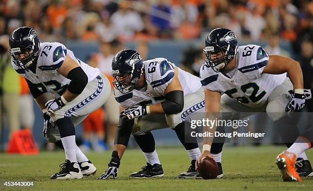 Offensive tackle Eric Winston, guard Stephen Schilling and center Greg Van Roten of the Seattle Seahawks line up against the Denver Broncos during...