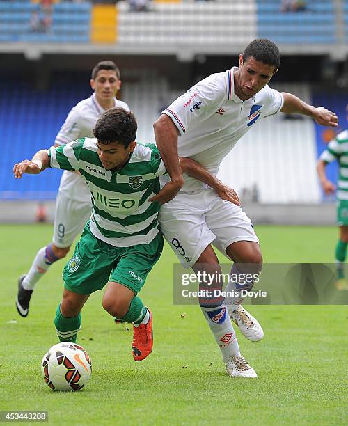 Andre Martins of Sporting Clube de Portugal is tackled by Diego Arismendi of Club Nacional de Football during the Teresa Herrera Trophy match between...