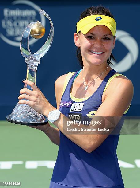 Agnieszka Radwanska of Poland kisses the trophy after defeating Venus Williams of the USA during the women's finals match at Uniprix Stadium on...