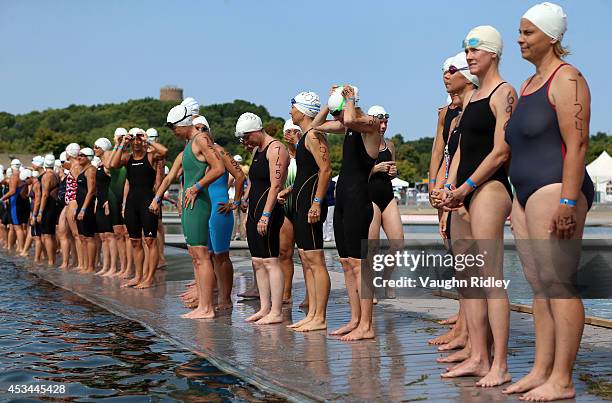 Swimmers prepare for the start of the Women's 45-49 Age Group 3km swim during the 15th FINA World Masters Championships at Parc Jean-Drapeau on...