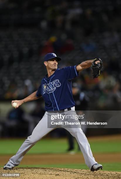 Grant Balfour of the Tampa Bay Rays pitches against the Oakland Athletics in the bottom of the tenth inning at O.co Coliseum on August 4, 2014 in...