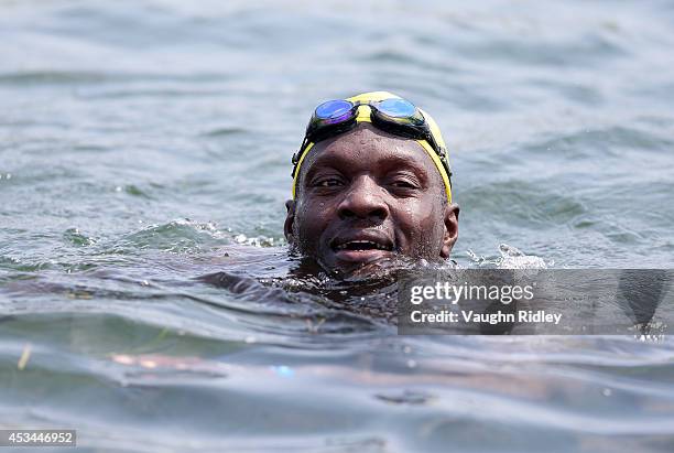 Board Member Mouhamedou Diop of Senegal competes in the Men's 50-54 Age Group 3km swim during the 15th FINA World Masters Championships at Parc...