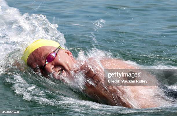 Igor Vazhenin of Russia competes in the Men's 50-54 Age Group 3km swim during the 15th FINA World Masters Championships at Parc Jean-Drapeau on...