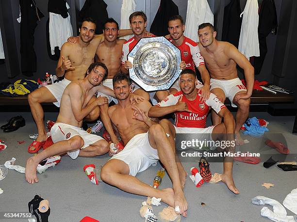 Mathieu Flamini, Tomas Rosicky, Santi Cazorla, Olivier Giroud, Nacho Monreal, Aaron Ramsey, Alex Oxlade-Chamberlain and Jack Wilshere celebrate after...