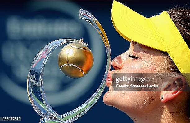 Agnieszka Radwanska of Poland kisses the trophy after defeating Venus Williams of the USA during the women's finals match at Uniprix Stadium on...