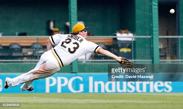 Travis Snider of the Pittsburgh Pirates can't catch a ball hit by Tommy Medica of the San Diego Padres during the eighth inning of their game on...