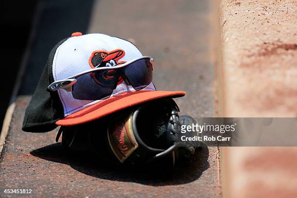 The hat and glove of Delmon Young of the Baltimore Orioles sits in the dugout during the third inning of the Orioles and St. Louis Cardinals game at...