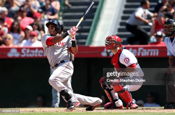 Yoenis Cedspedes of the Boston Red Sox hits a three run home run to break a scoreless tie in the eighth inning against the Los Angeles Angels of...